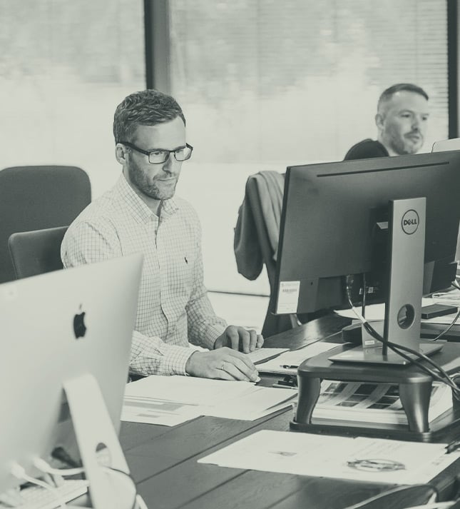 Two colleagues reviewing intelligent document processing on a laptop
