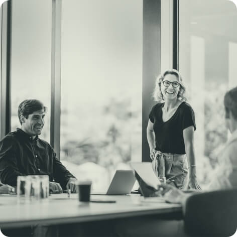 Two-business-women-talking-sales-walking-in-office_unsplash (1)